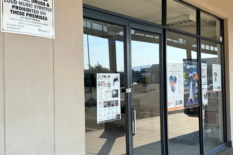 MobiDokta repair and gaming lounge posters in the Shop 6 window at Madeira Isles